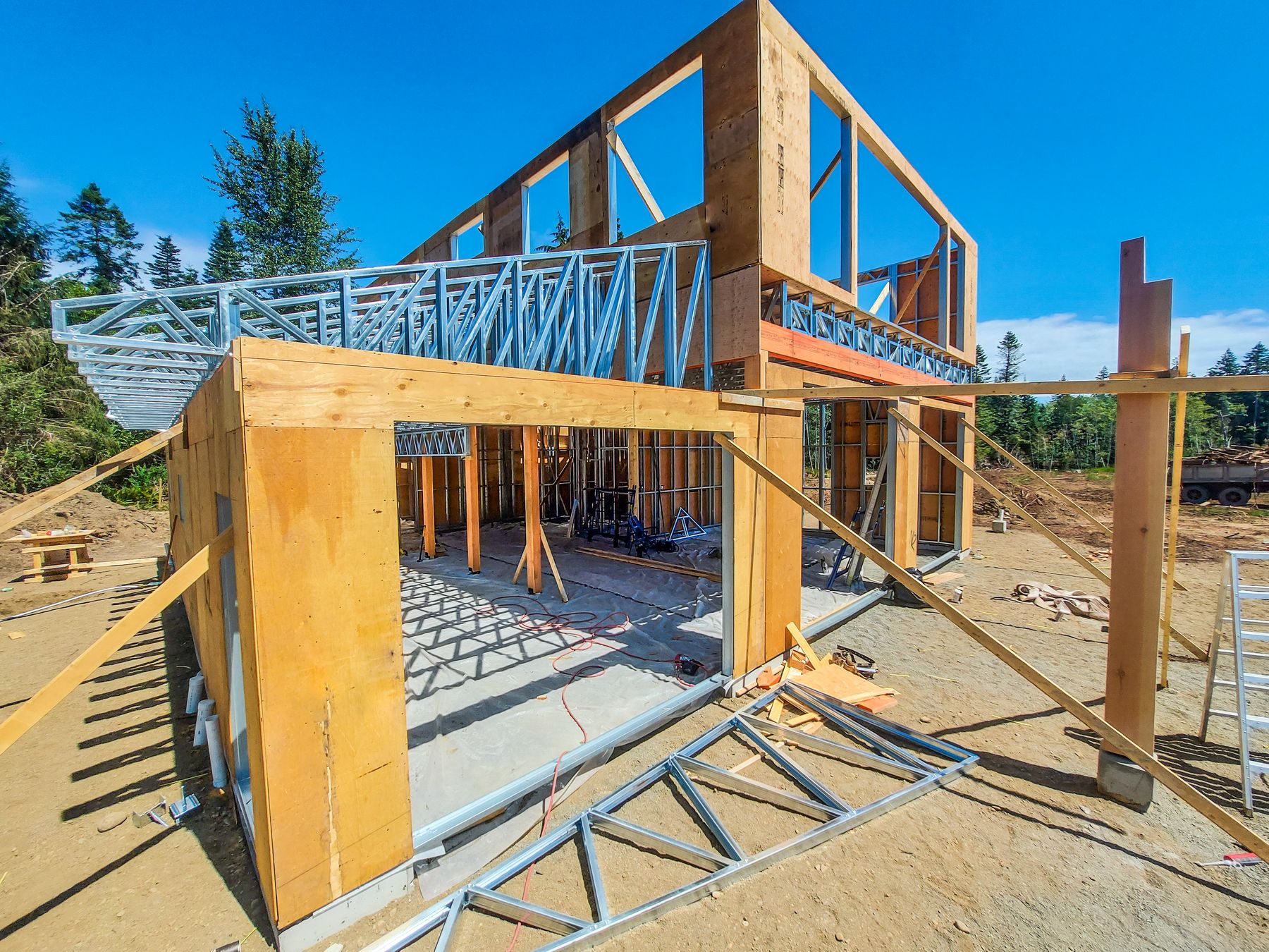 A modular structure with walls and roof framed and sheathed, mid-construction, partially finished